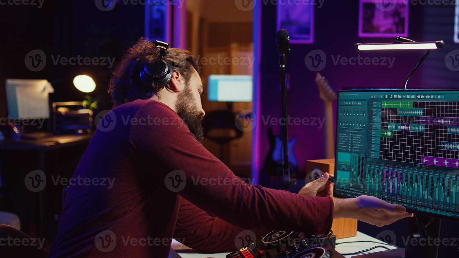 Audio engineer inserting an usb stick in the pc to record himself playing piano, mixing sounds and adjusting volume levels. Artist mastering audio recordings ready for release. Camera B. photo