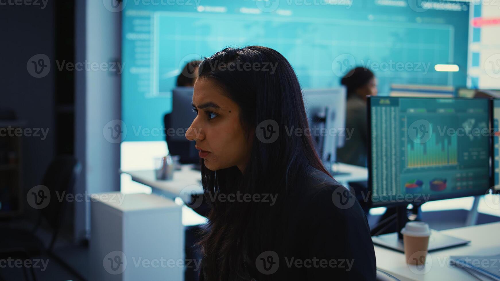 Indian office administrator explores partnership opportunities for the global business expansion plans, establishing current enterprise objectives. Analyst doing a win or loss study. Camera B. photo