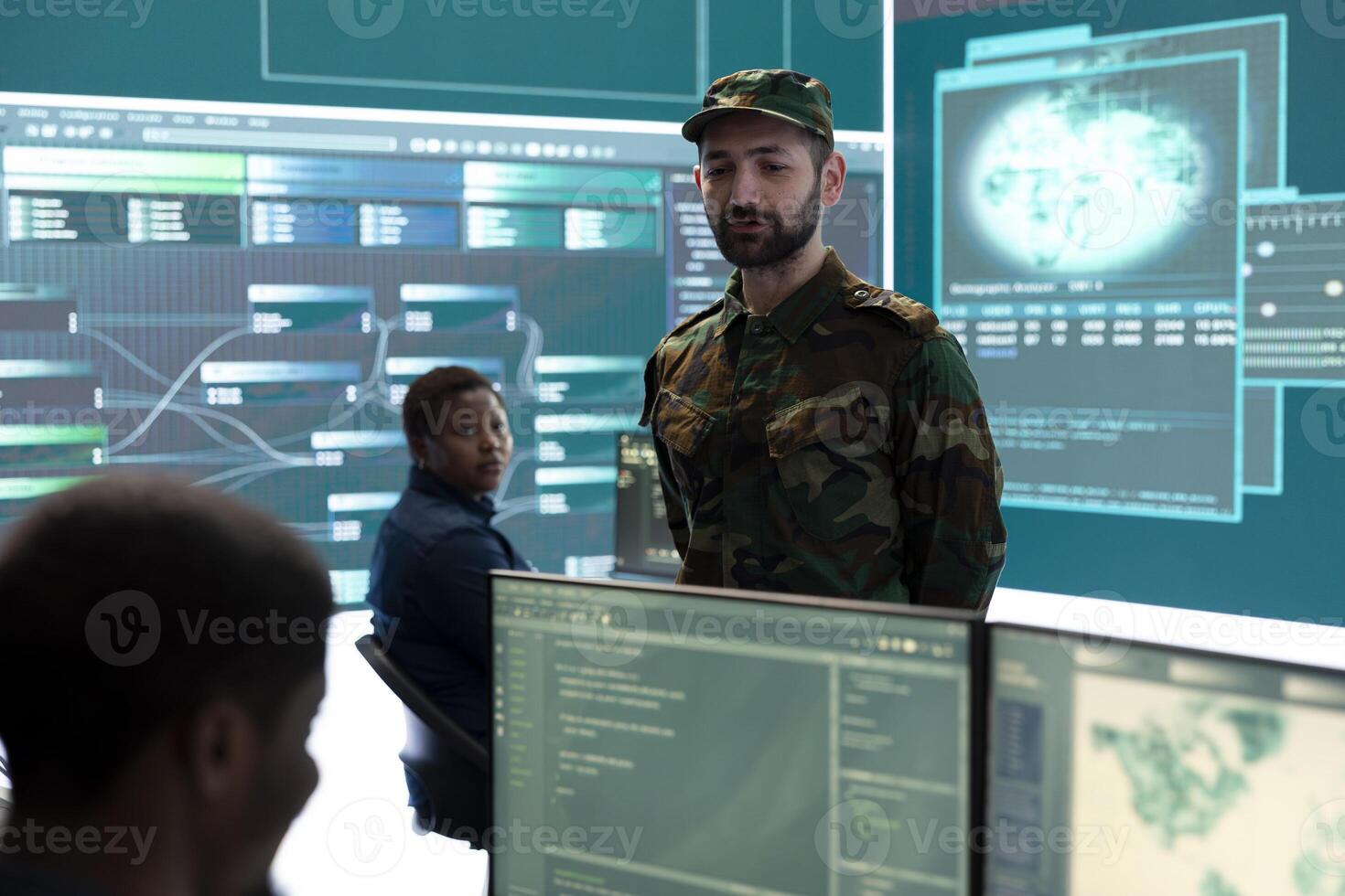 Military IT experts conducting surveillance and espionage activities using advanced technology and big screen. Governmental agency protecting against cyber threats and digital mercenaries. photo