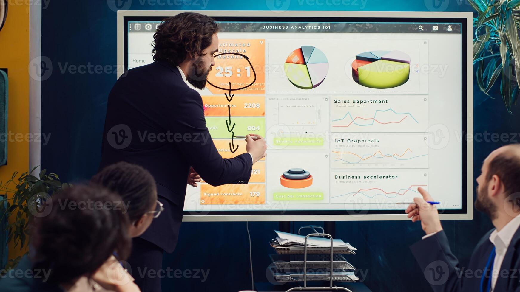 Project manager does a market research presentation for his team, better understanding of the situation. Associates work on technology or infrastructure investments to fulfill objectives. Camera A. photo