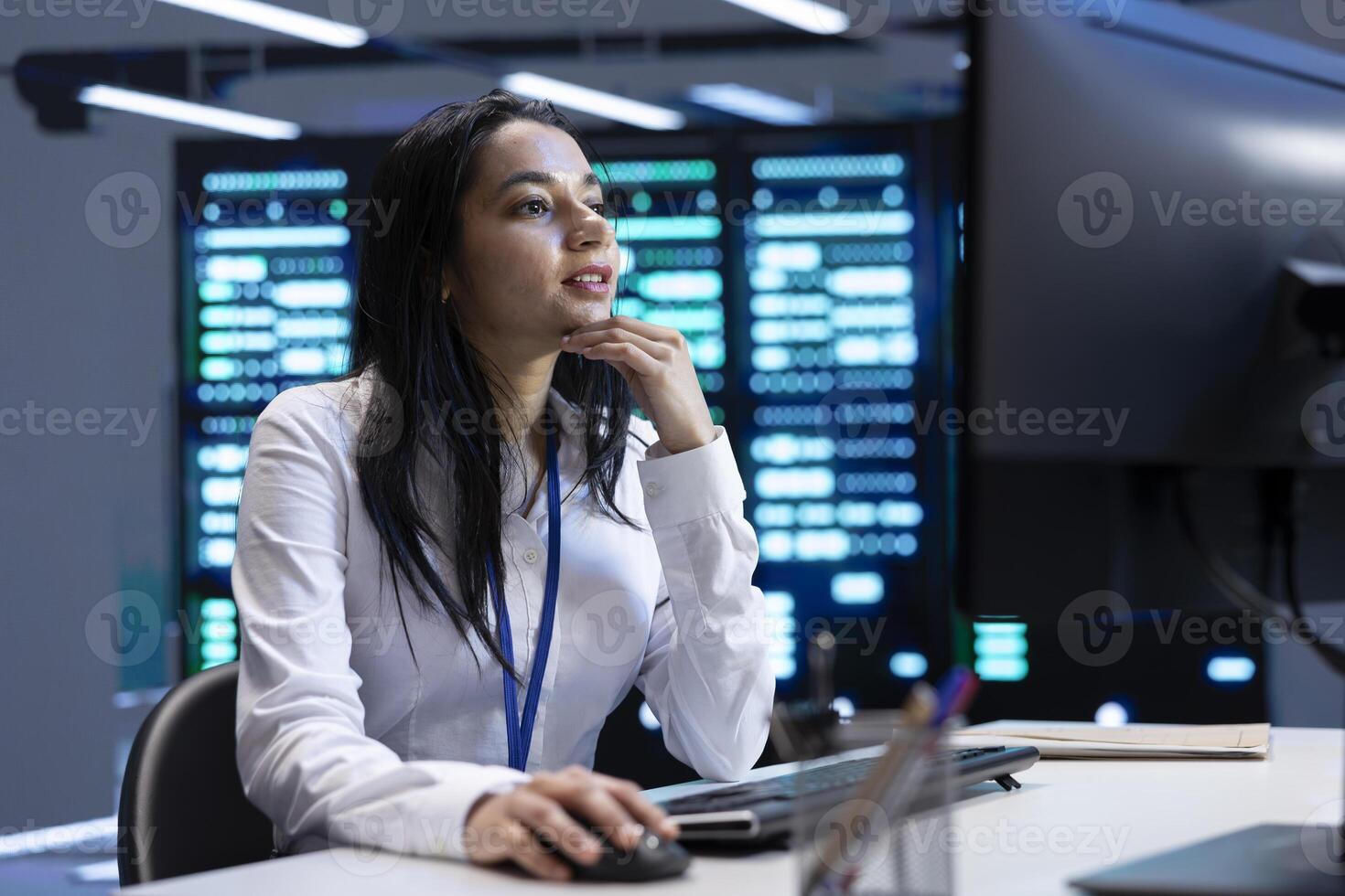 Admin in data center using computer to check for server performance issues arising due to high CPU usage. Server room employee at PC fixing insufficient memory errors slowing down hardware photo