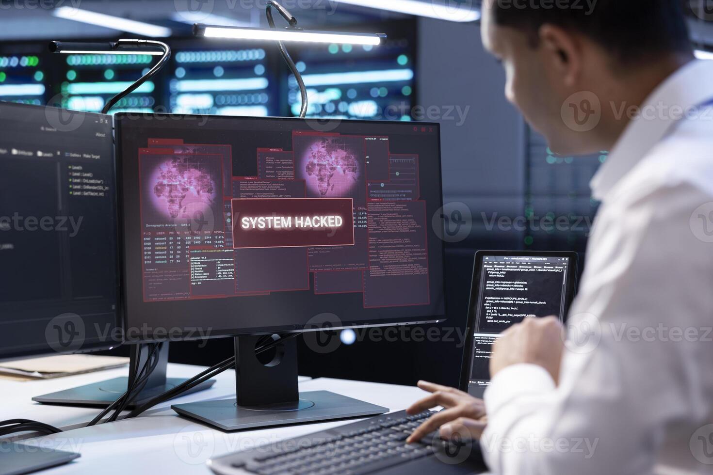 Admin in server hub trying to protect hardware from hacker attack stealing sensitive information. Data center employee struggling to erase virus after seeing security breach alert on monitor photo