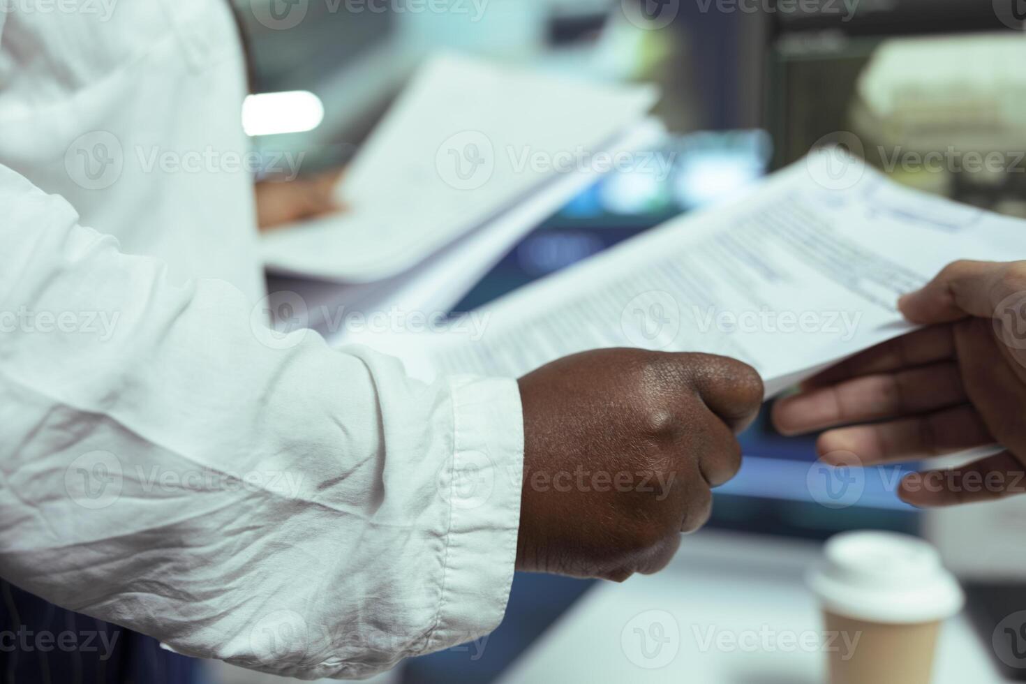 African american team leader gives order information for shipment logistics, provides awb and receipt to her staff. Proceeding with gps and directions on satellite map, control center. Close up. photo