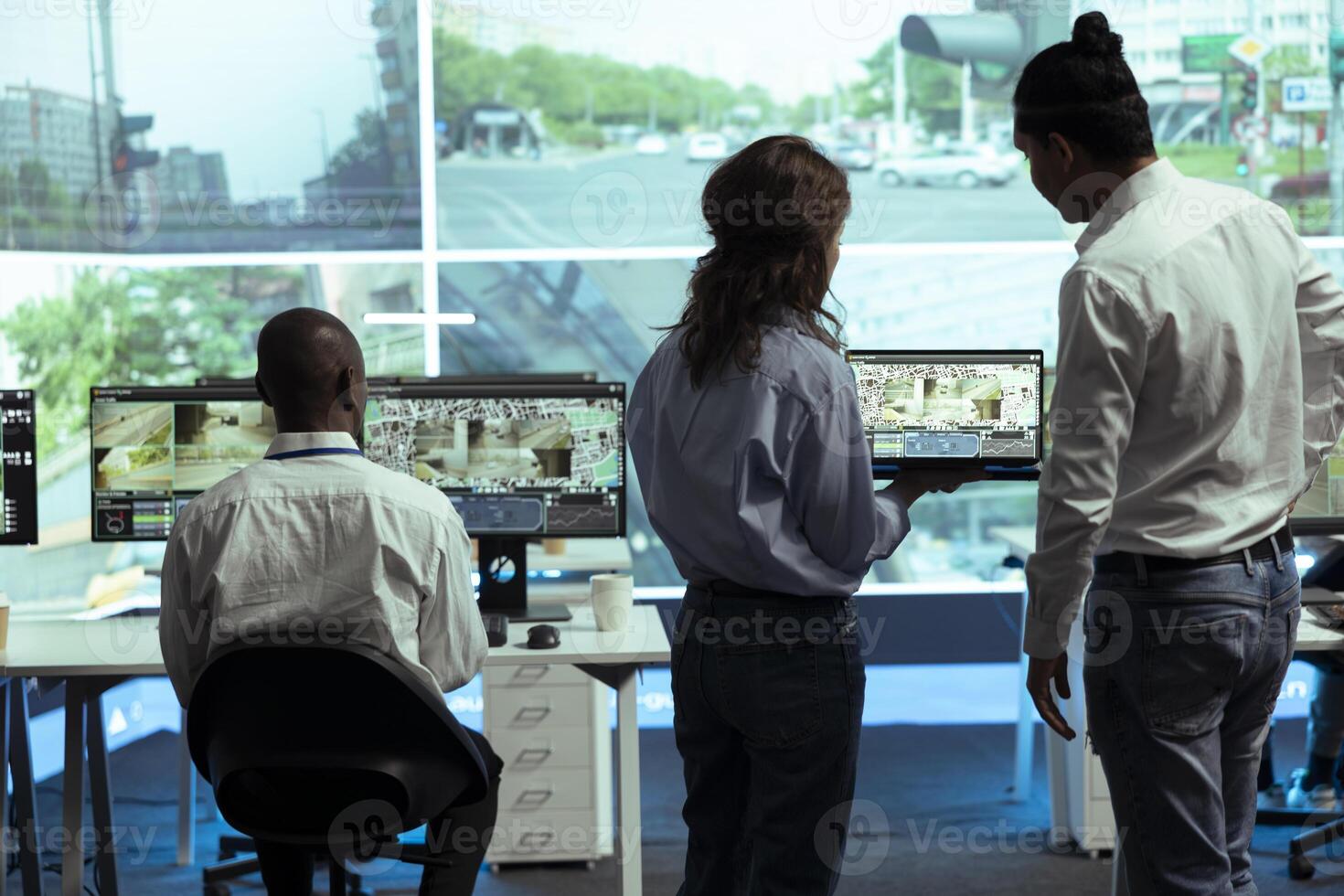 Agency employees operating on satellite map of the city to send gps coordinates for route to avoid traffic, helping couriers to delivery their orders in time. Operators monitoring their cars. photo