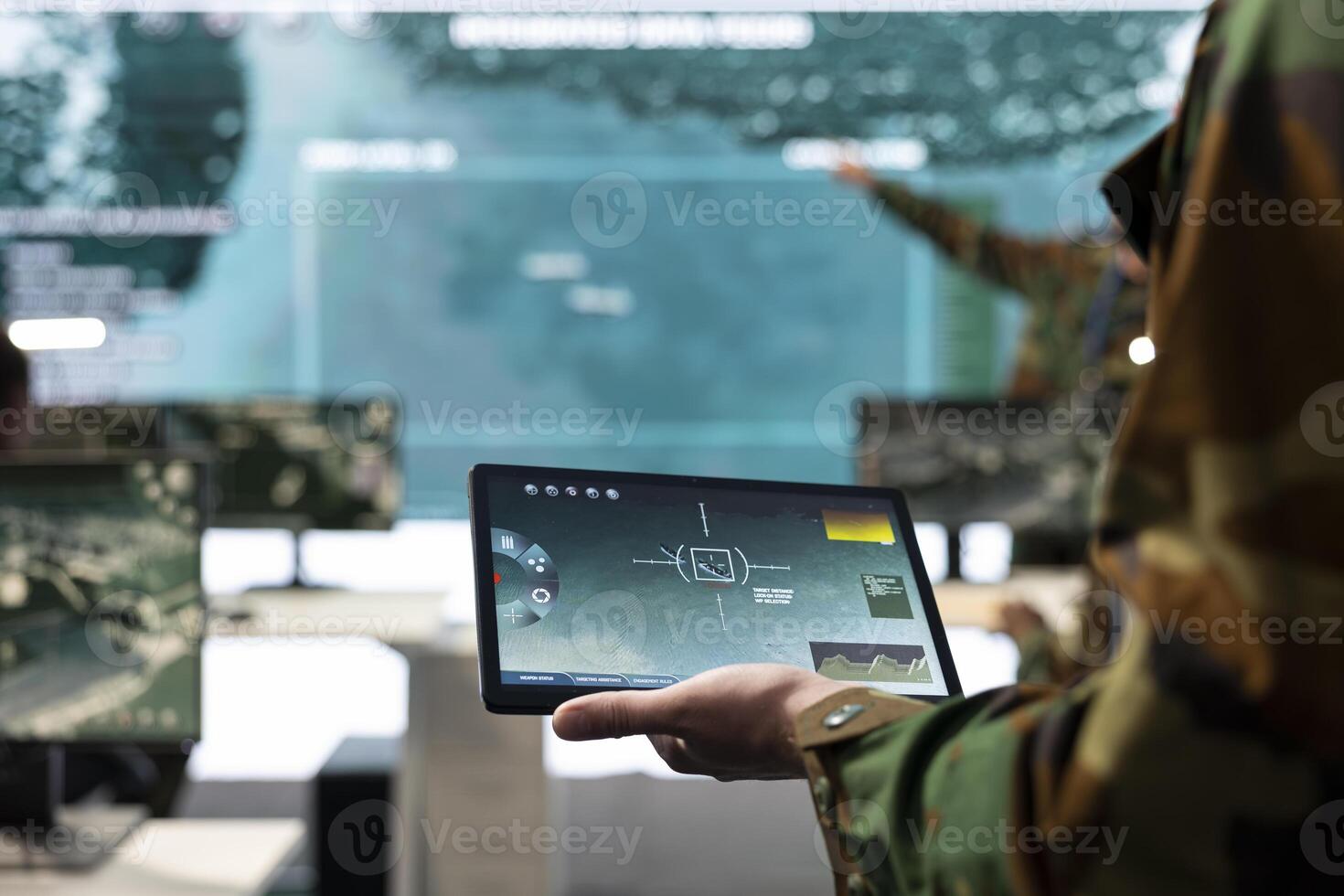 Army conscript detecting targets on a satellite world map to ensure national safety, operates on tablet in military power base of operations. Private examines battlefield real time data. Close up. photo