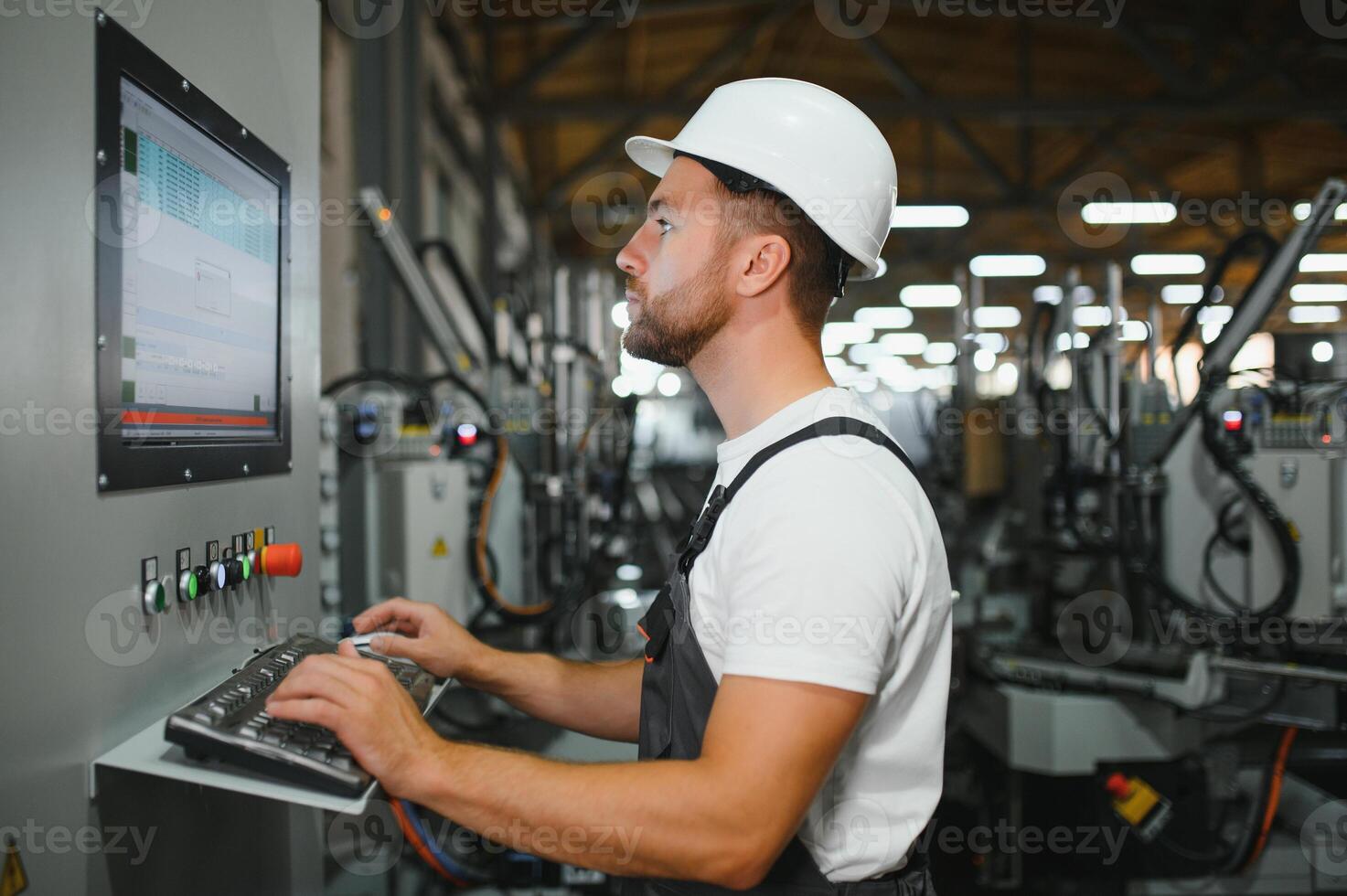 Technician operating machine in a factory photo