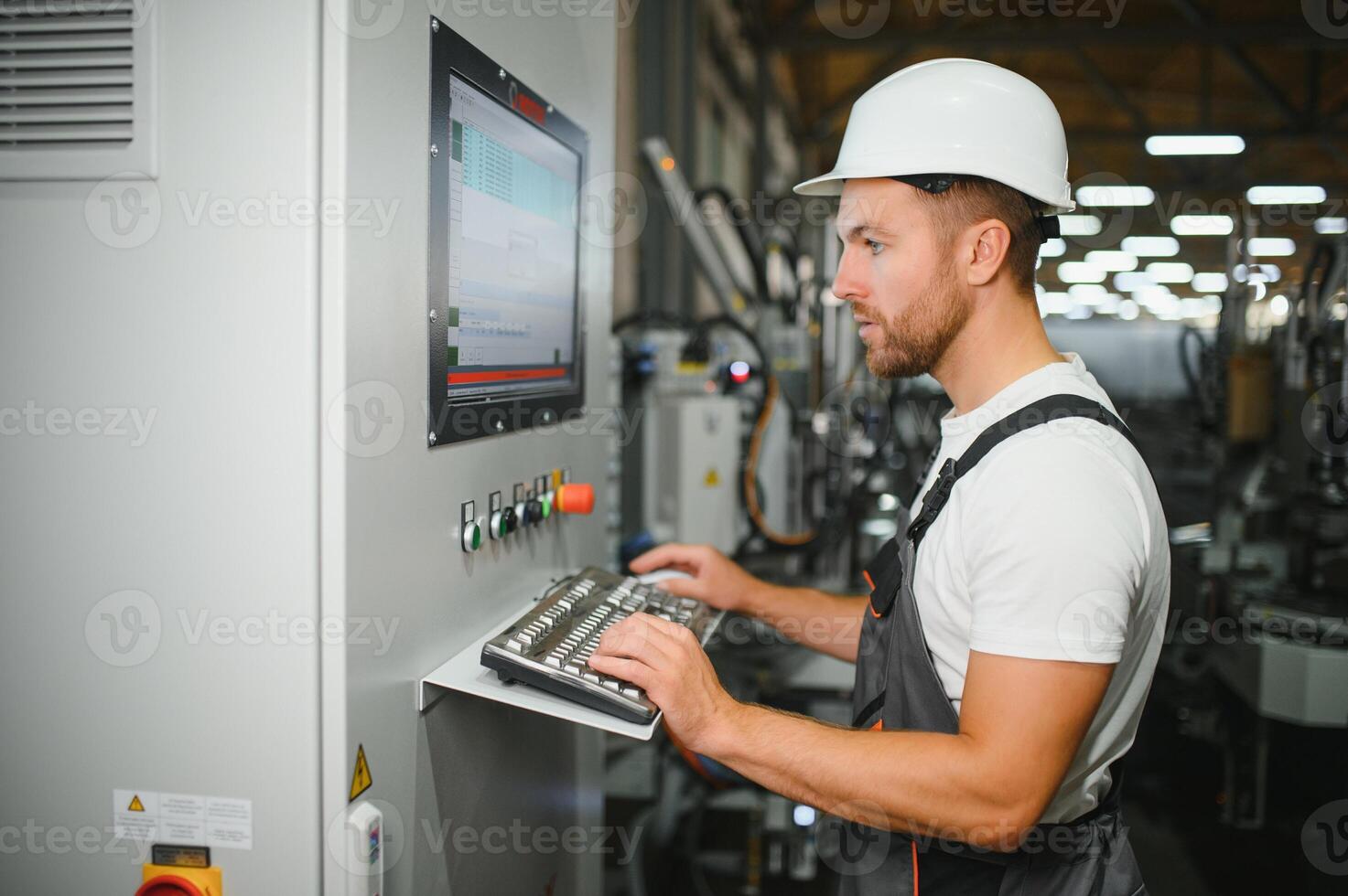 Technician operating machine in a factory photo