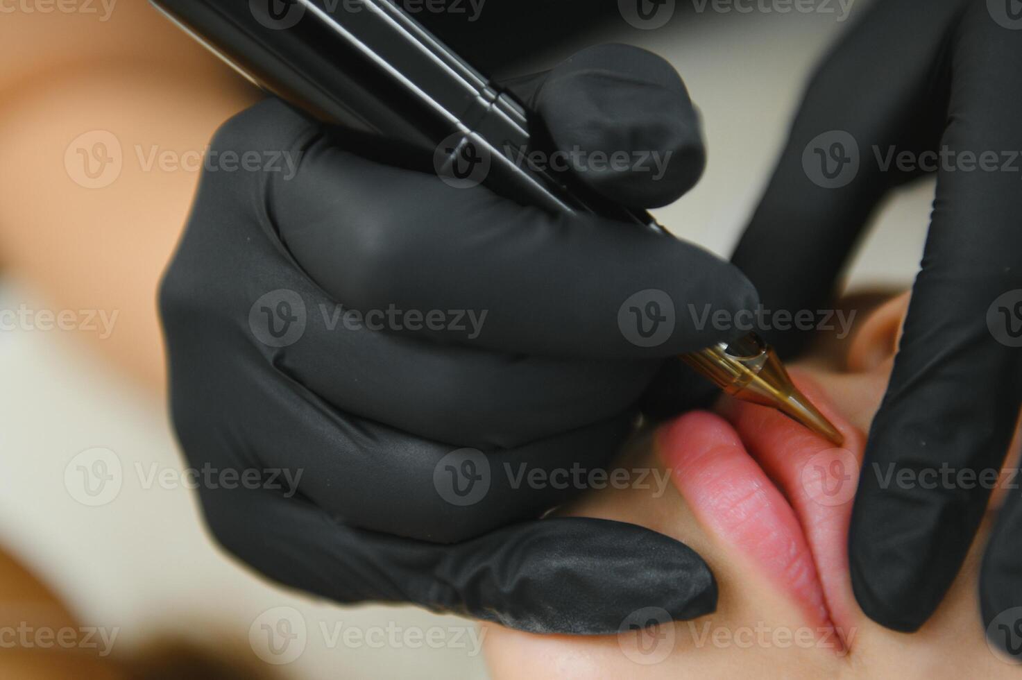 process of applying permanent makeup tattoo of red on lips woman photo