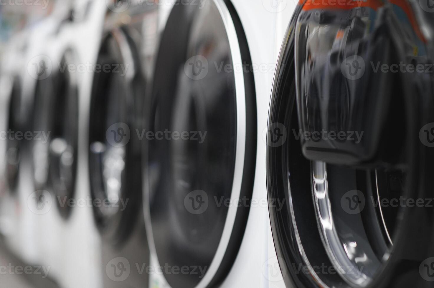 Rows of modern washing machines in a store photo