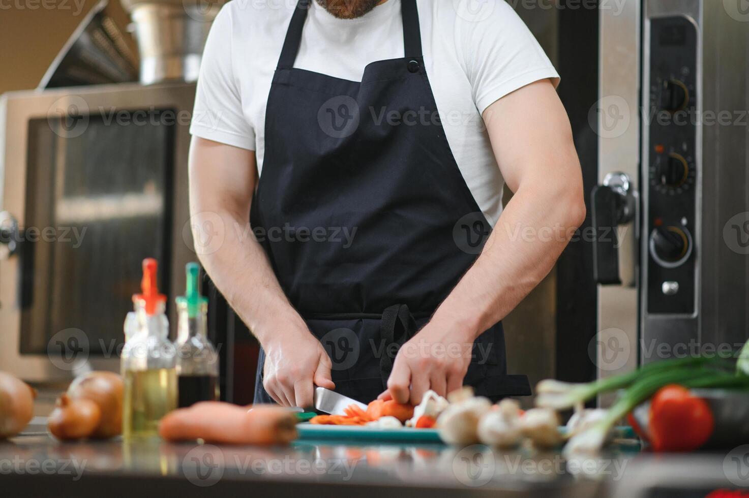 Chef cook preparing vegetables in his kitchen photo