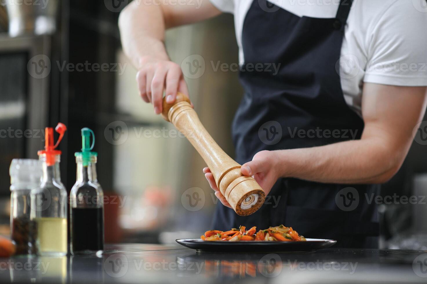 Chef cook in uniform cooking in the big cooker at the restaurant kitchen photo