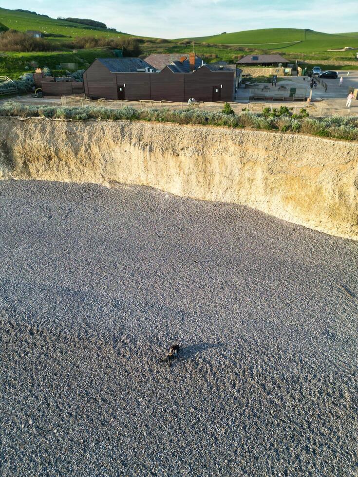 High Angle View of British Tourist Attraction of United Kingdom at Beachy Head headland Sea View and Ocean at Eastbourne, East Sussex, England. Drone's Camera Footage Was Captured on May 10th, 2024 photo