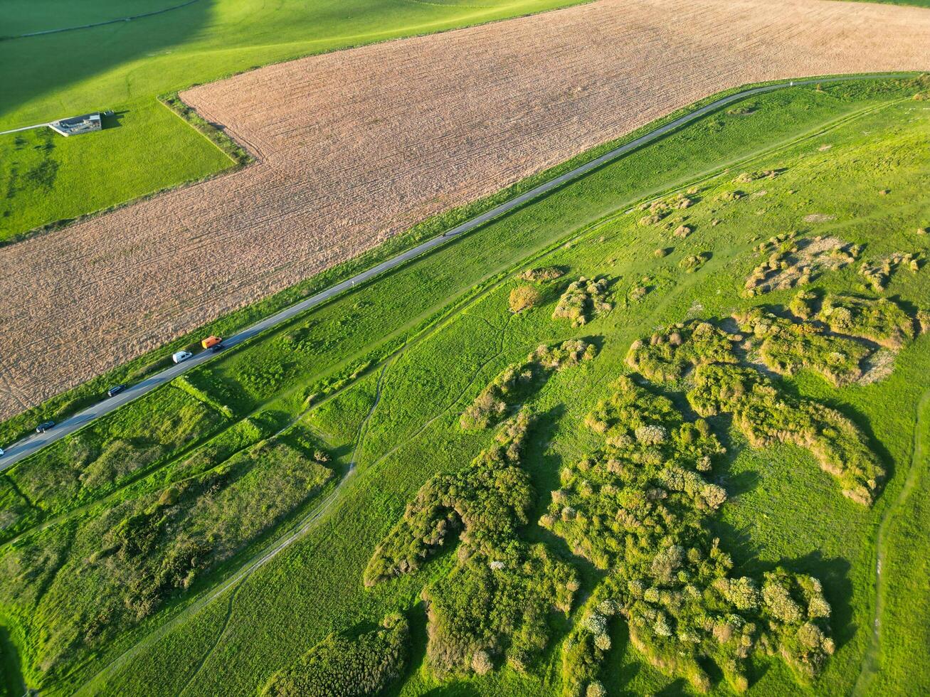 High Angle View of British Tourist Attraction of United Kingdom at Beachy Head headland Sea View and Ocean at Eastbourne, East Sussex, England. Drone's Camera Footage Was Captured on May 10th, 2024 photo