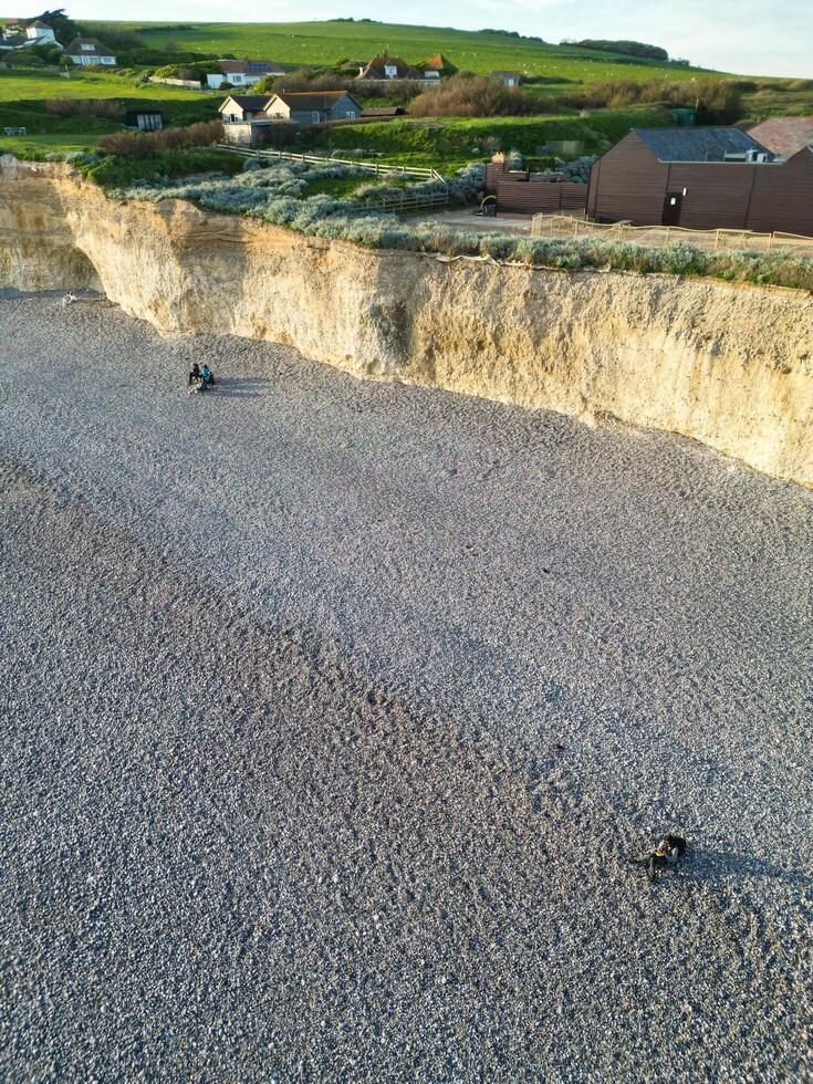 High Angle View of British Tourist Attraction of United Kingdom at Beachy Head headland Sea View and Ocean at Eastbourne, East Sussex, England. Drone's Camera Footage Was Captured on May 10th, 2024 photo