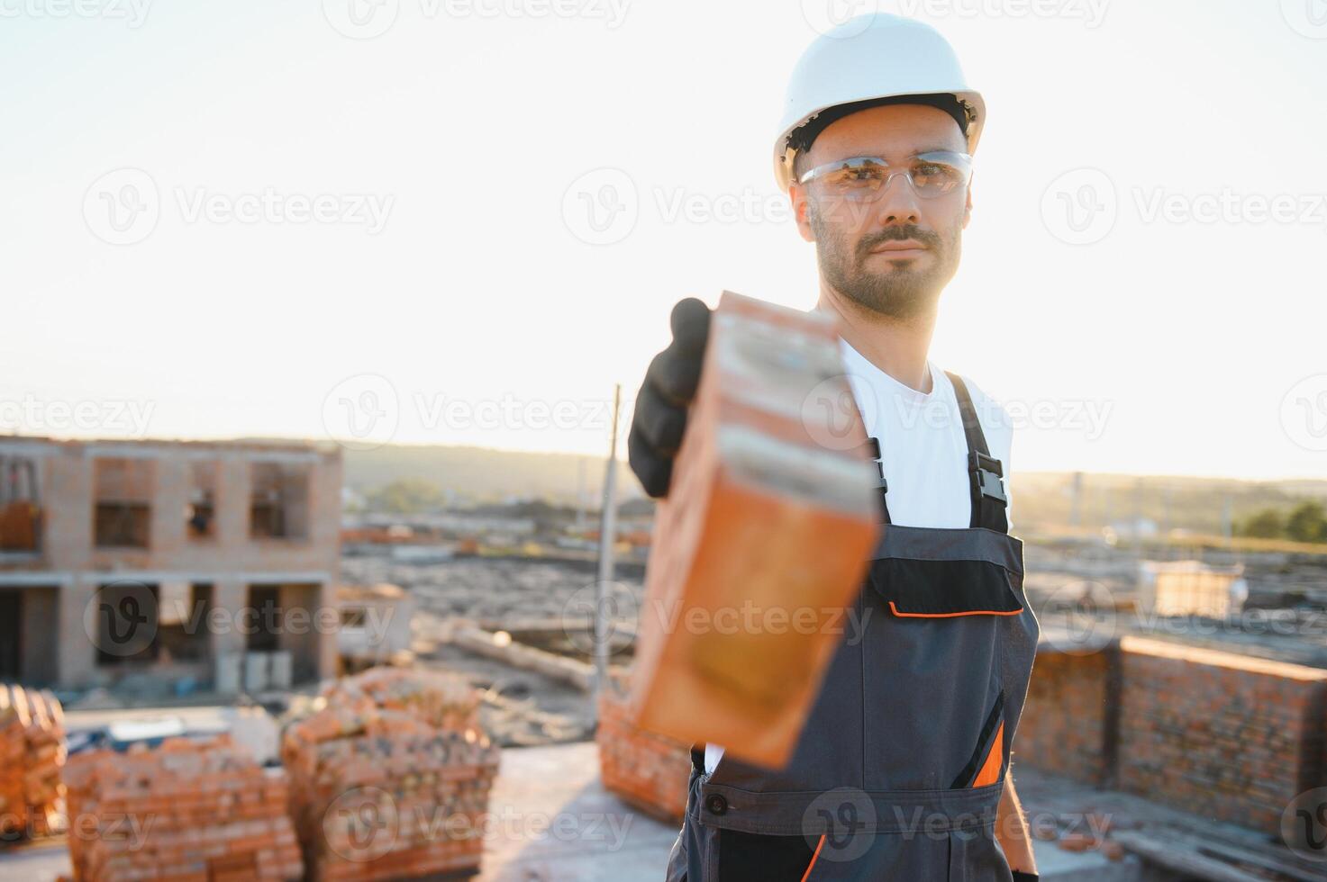 Construction worker in uniform and safety equipment have job on building photo