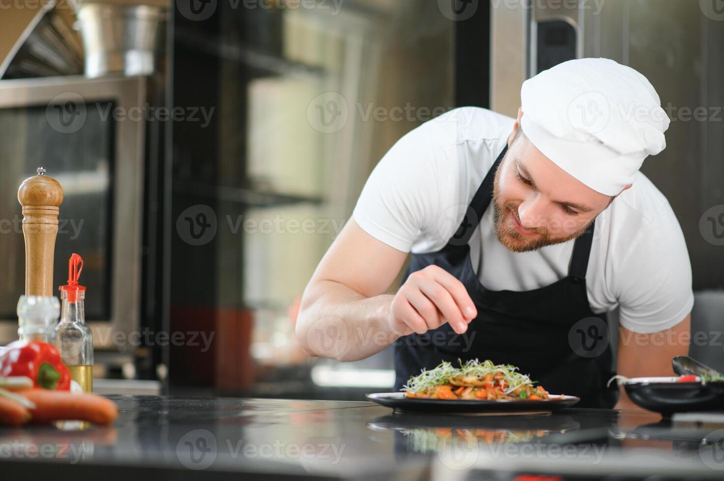 Chef cook in uniform cooking in the big cooker at the restaurant kitchen photo