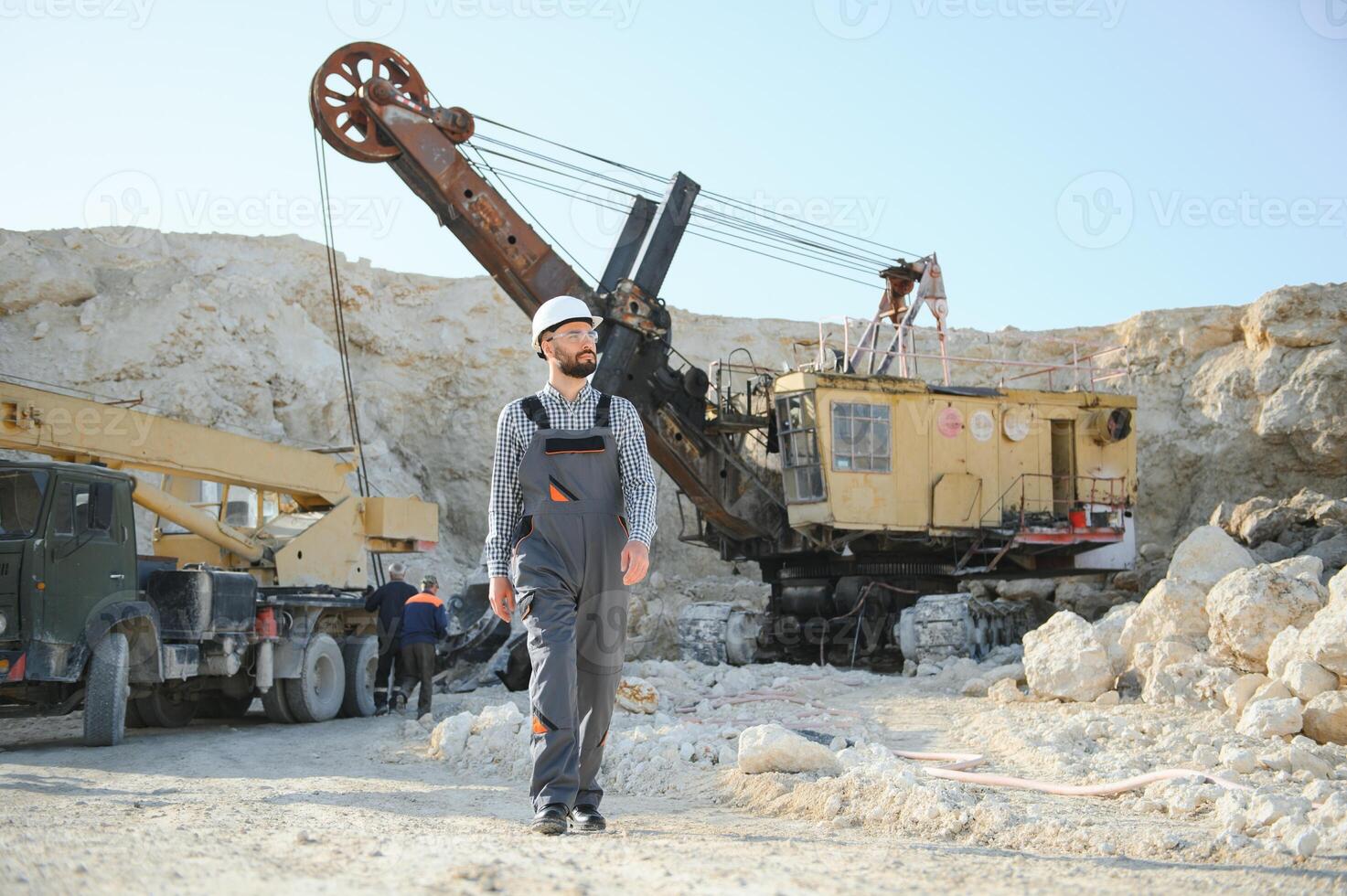 Portrait of a worker standing on the background of a stone quarry photo