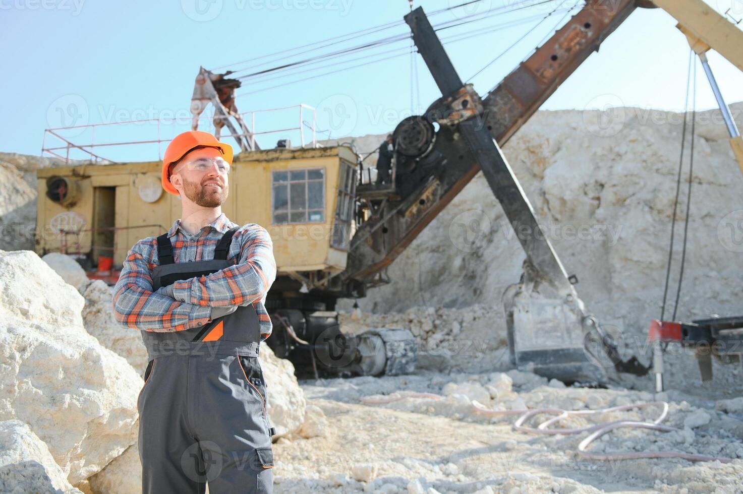 Worker and quarry in background photo