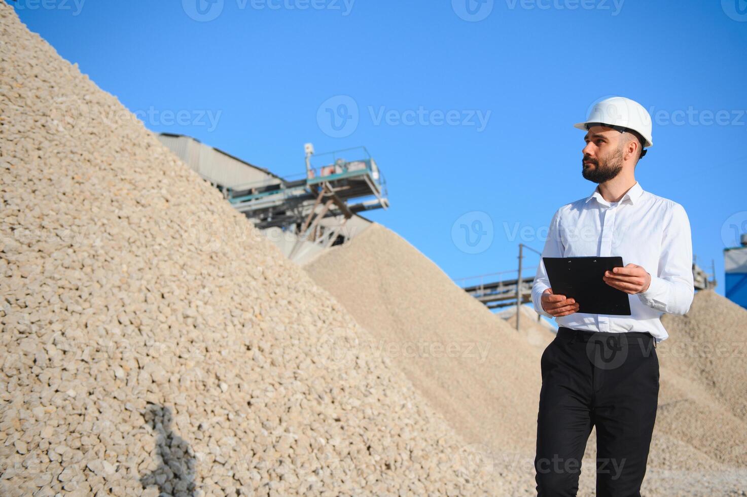 An engineer at a crushed stone or gravel plant. Stone mining photo