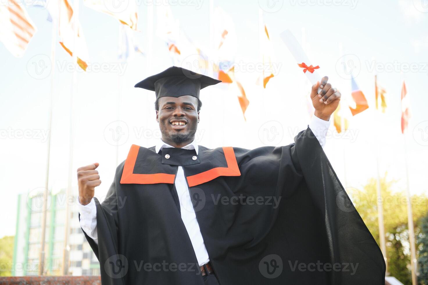Happy graduate. Happy African man in graduation gowns photo