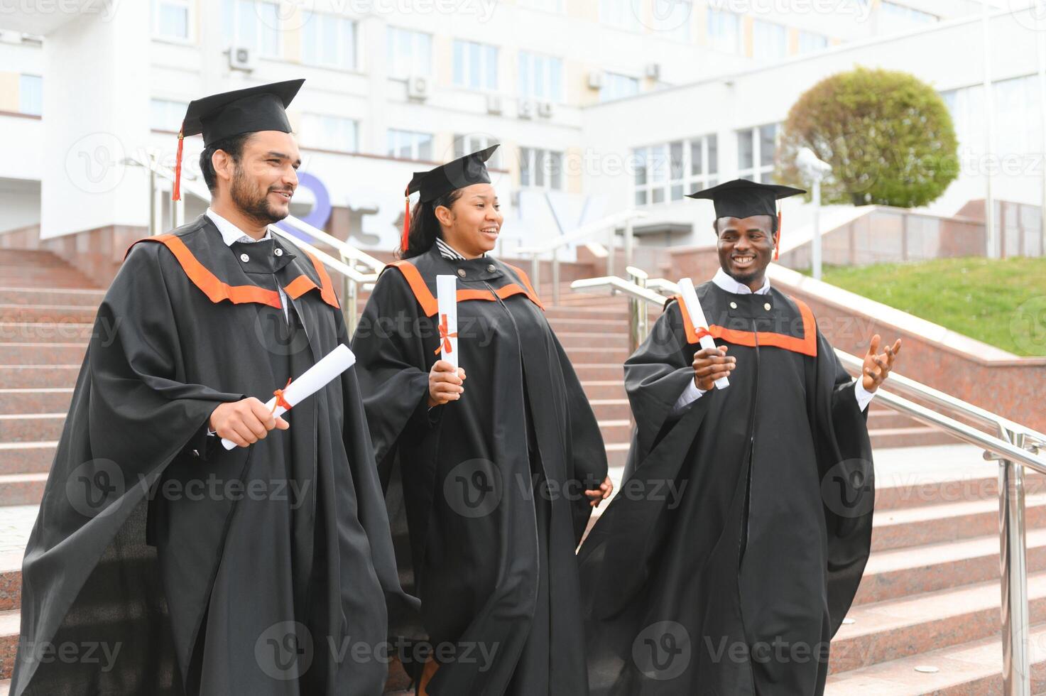 Diverse international students with diplomas attending graduation ceremony, happy multiracial group of students photo