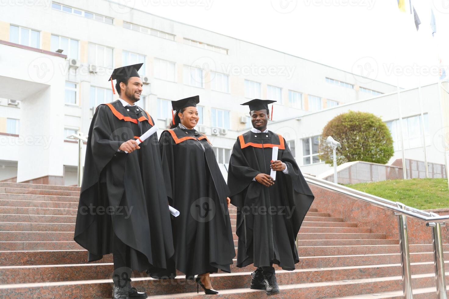 Diverse international students with diplomas attending graduation ceremony, happy multiracial group of students photo