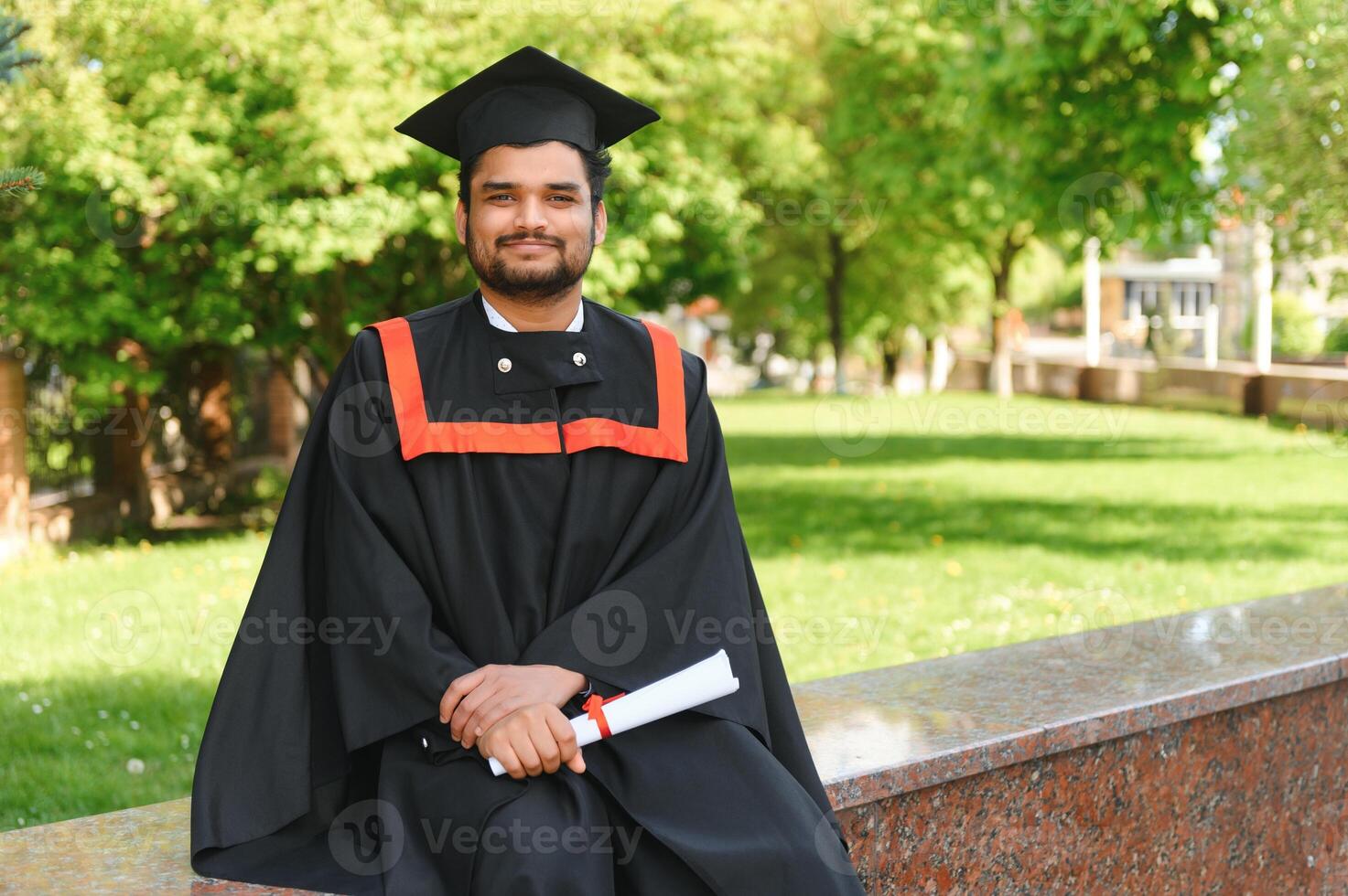 education, graduation and people concept - happy Indian Male graduate student photo