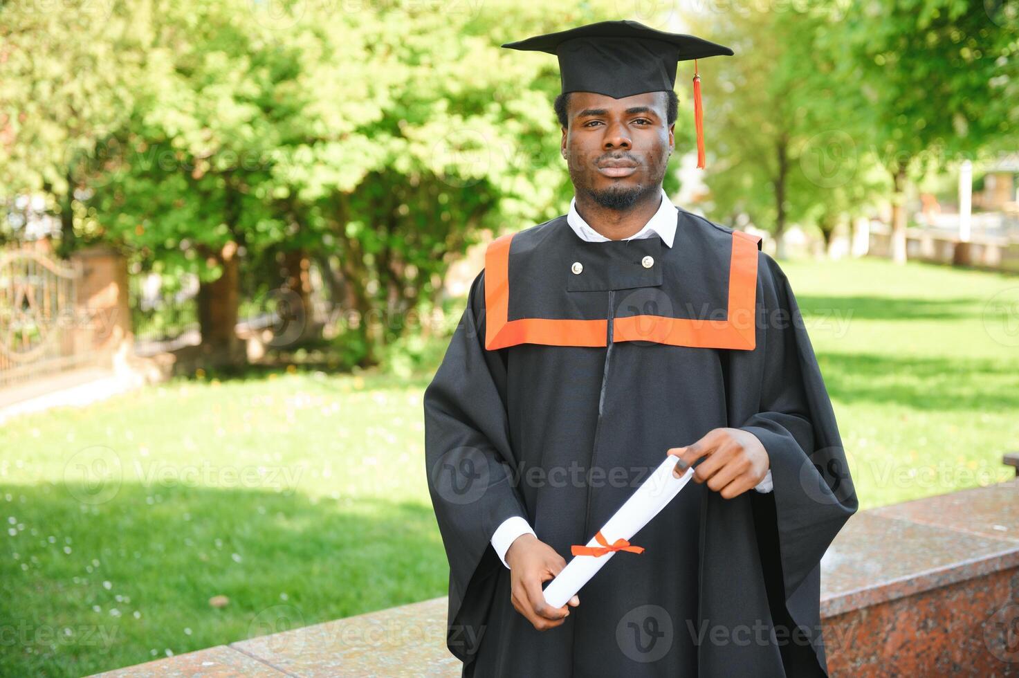Happy graduate. Happy African man in graduation gowns photo