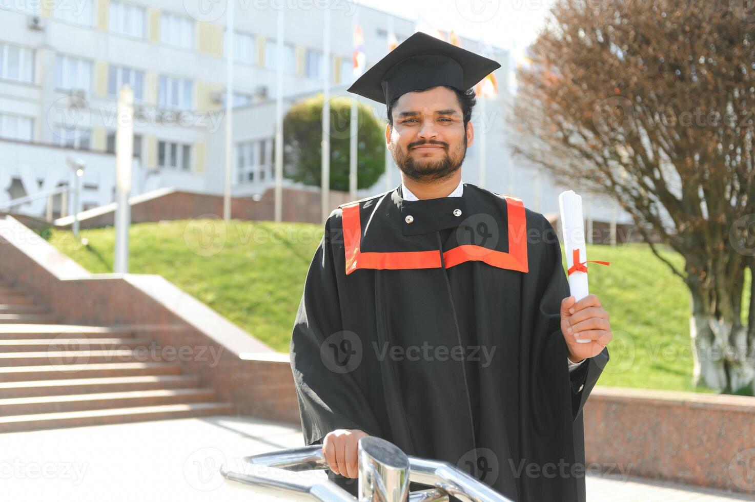 Portrait of happy man, graduation or student in university campus photo