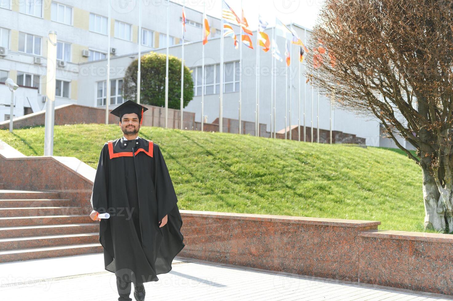 education, graduation and people concept - happy Indian Male graduate student photo