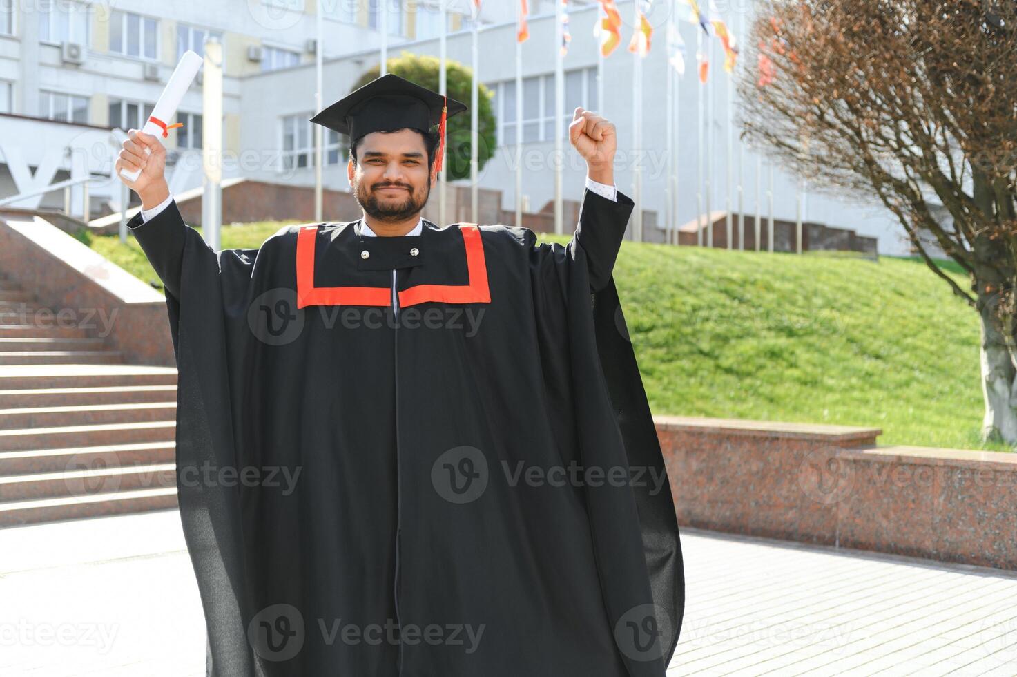 education, graduation and people concept - happy Indian Male graduate student photo