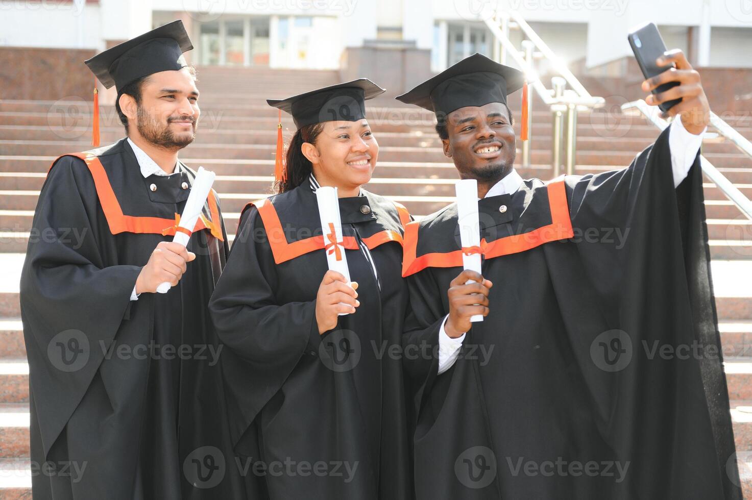 Diverse international students with diplomas attending graduation ceremony, happy multiracial group of students photo