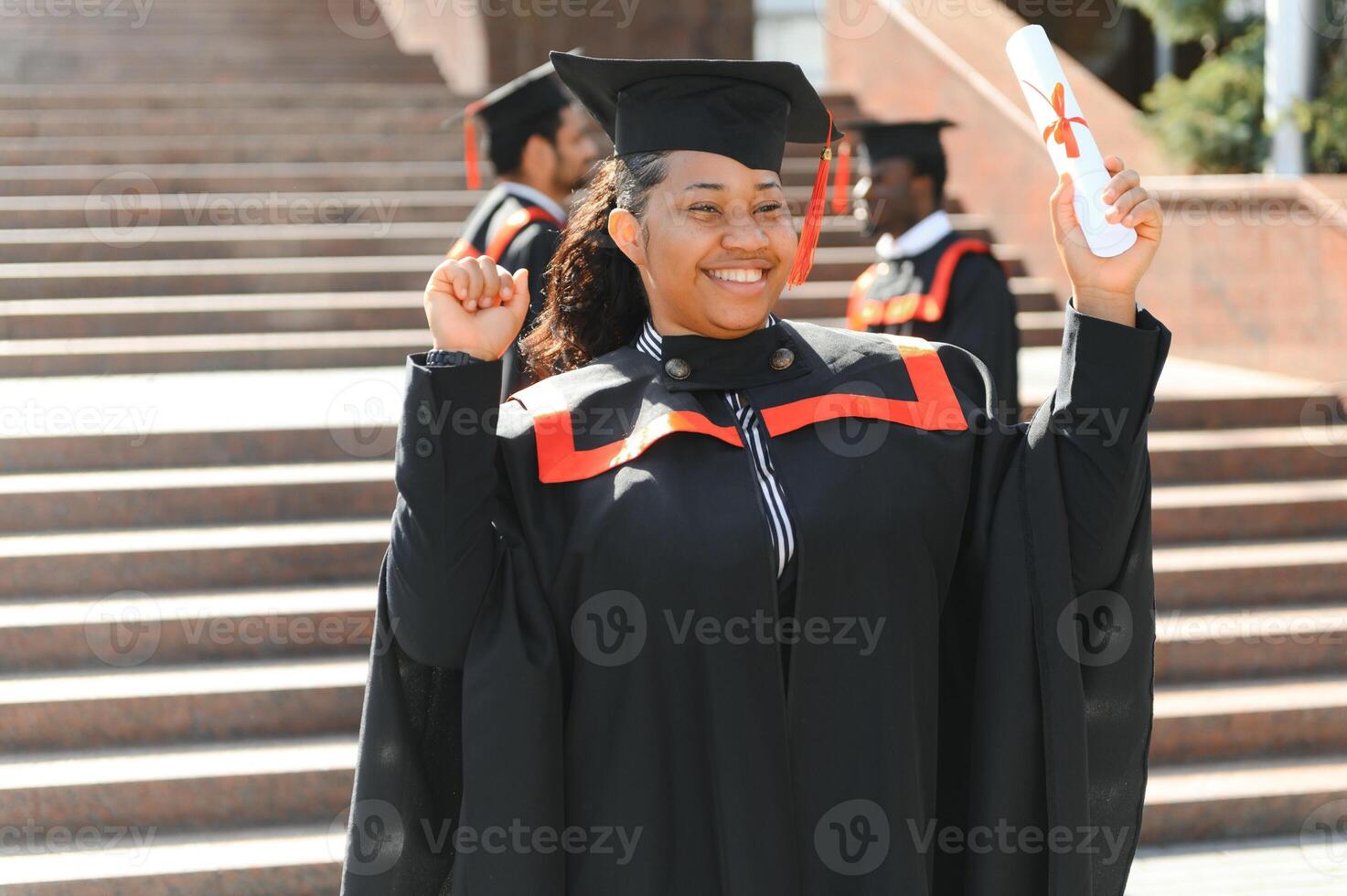 pretty african university graduate at graduation ceremony photo