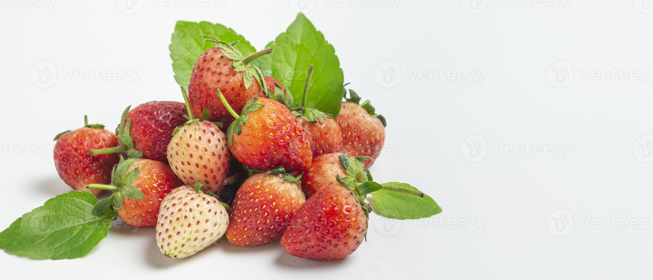 strawberries with leaves on white background photo