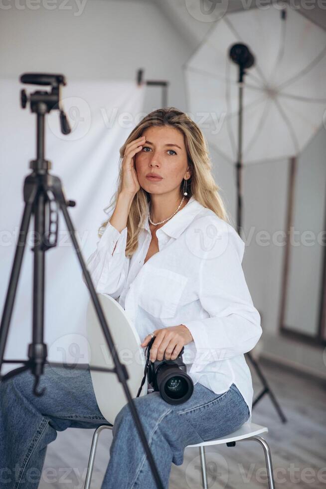 Woman photographer in a studio setting, using gear to capture creative images. photo