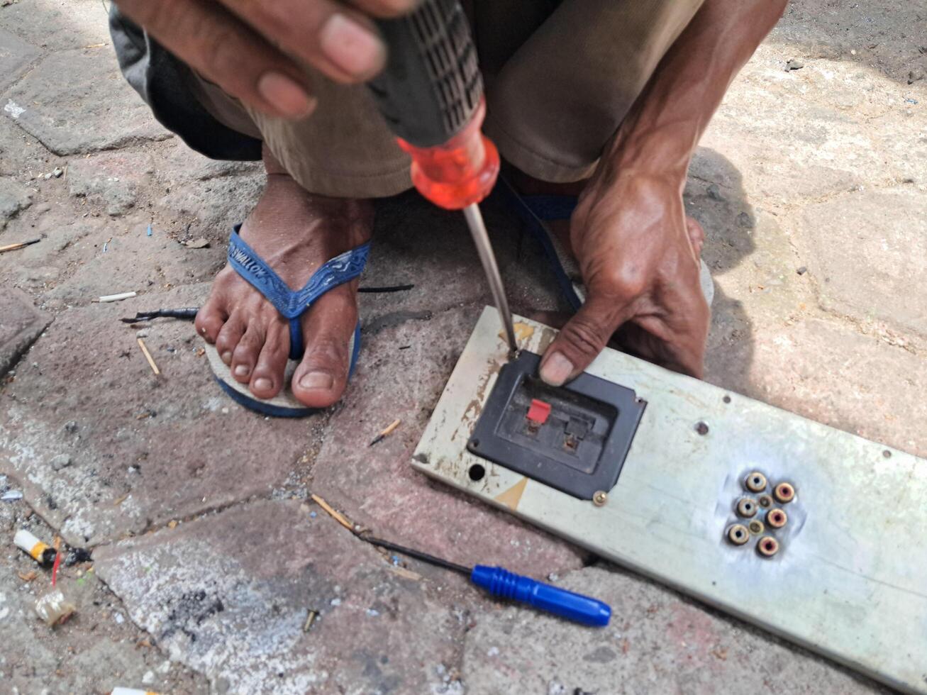 a mechanic is repairing electronic machine components photo