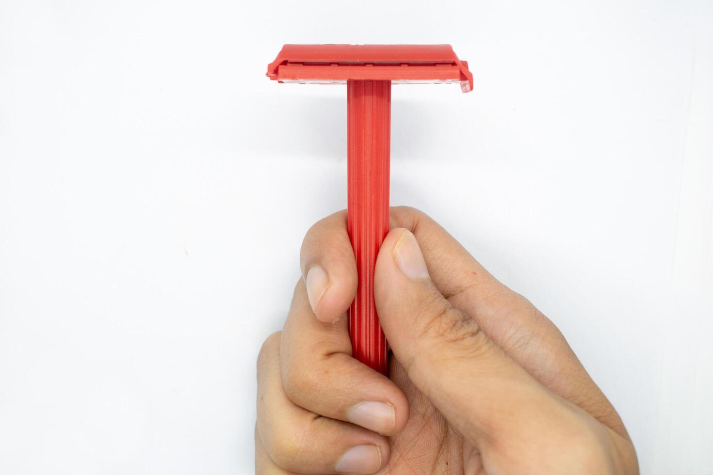 hand holding a razor on a white background photo