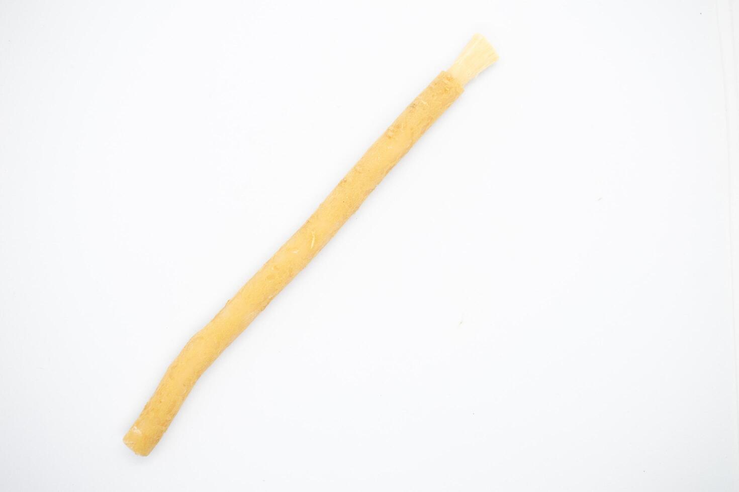 old traditional islamic natural toothbrush miswak or siwak, on white background photo