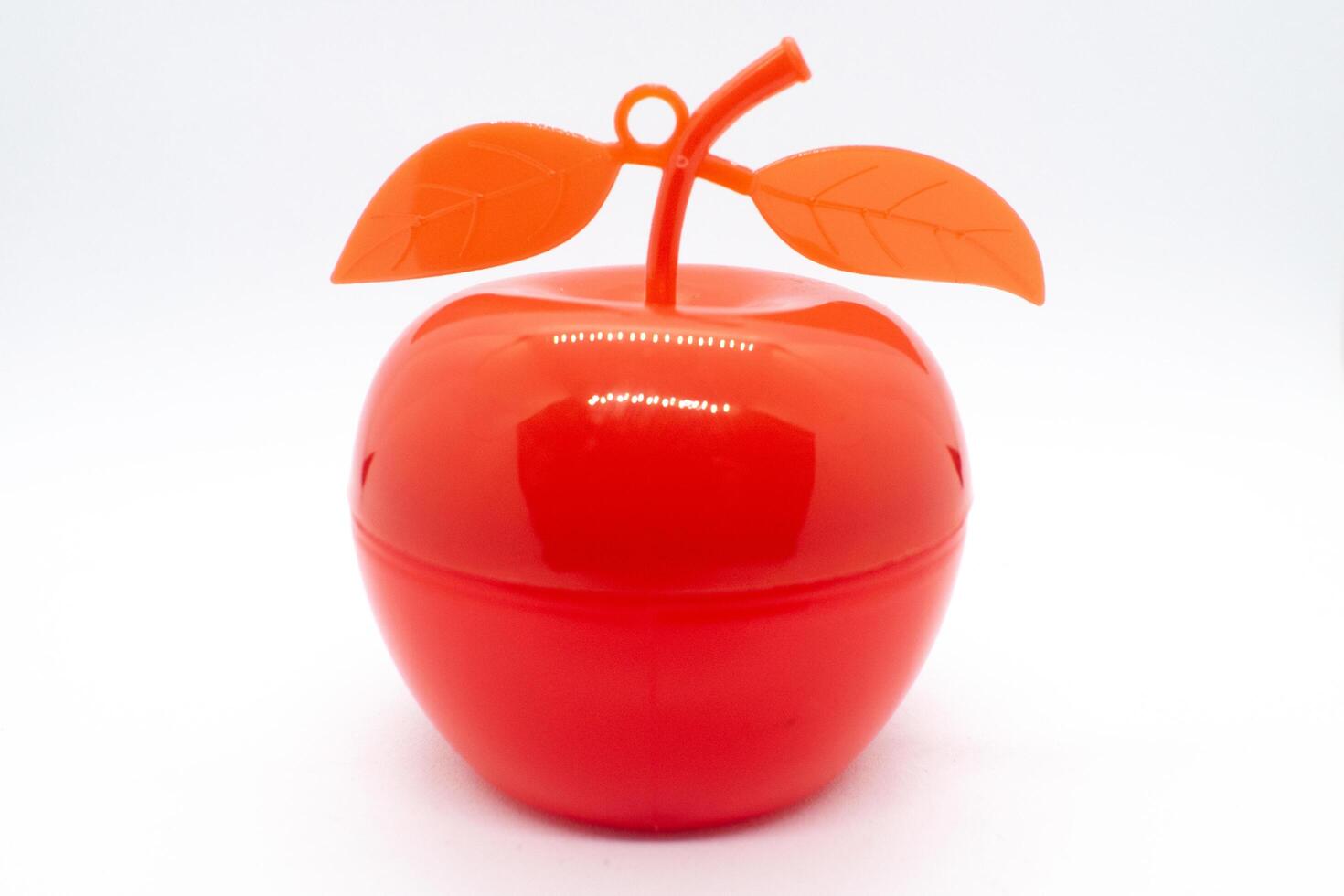 Children's toy in the shape of a red apple on a white background photo