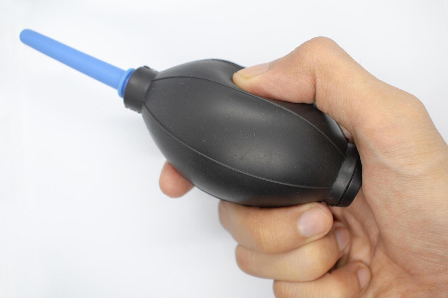 A dust air blower in hand isolated on a white background photo
