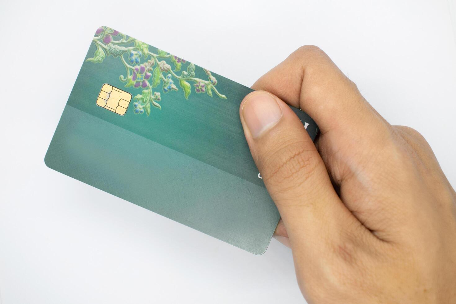 hand holding bank card on isolated white background. photo