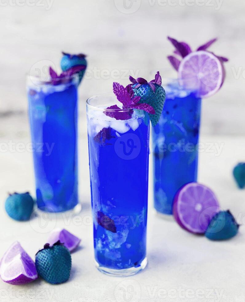 Blueberry lemonade cocktail with purple flowers photo