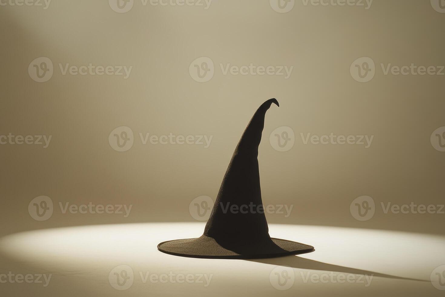 A Black Witch Hat Standing Tall on a White Surface photo