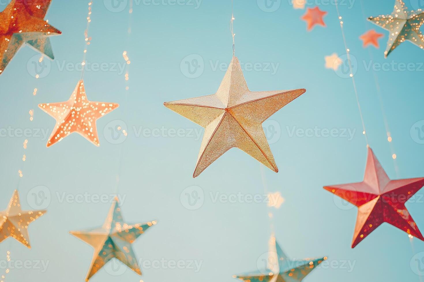 Festive String of Glittering Stars Hanging Against a Blue Sky photo