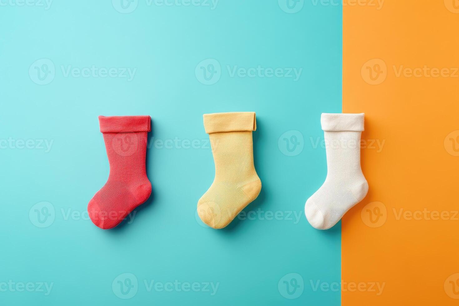 Three Colorful Socks on a Blue and Orange Background photo