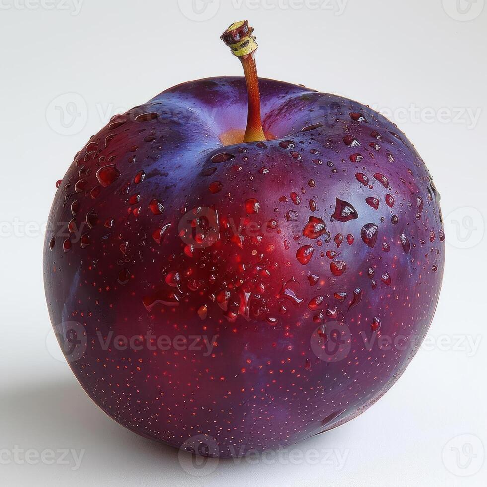 An apple with water droplets on its surface, indicating recent rainfall. photo