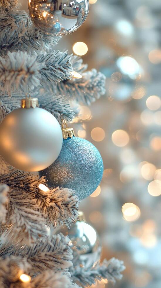 Decorative silver baubles on a Christmas tree with blurred lights in the background photo