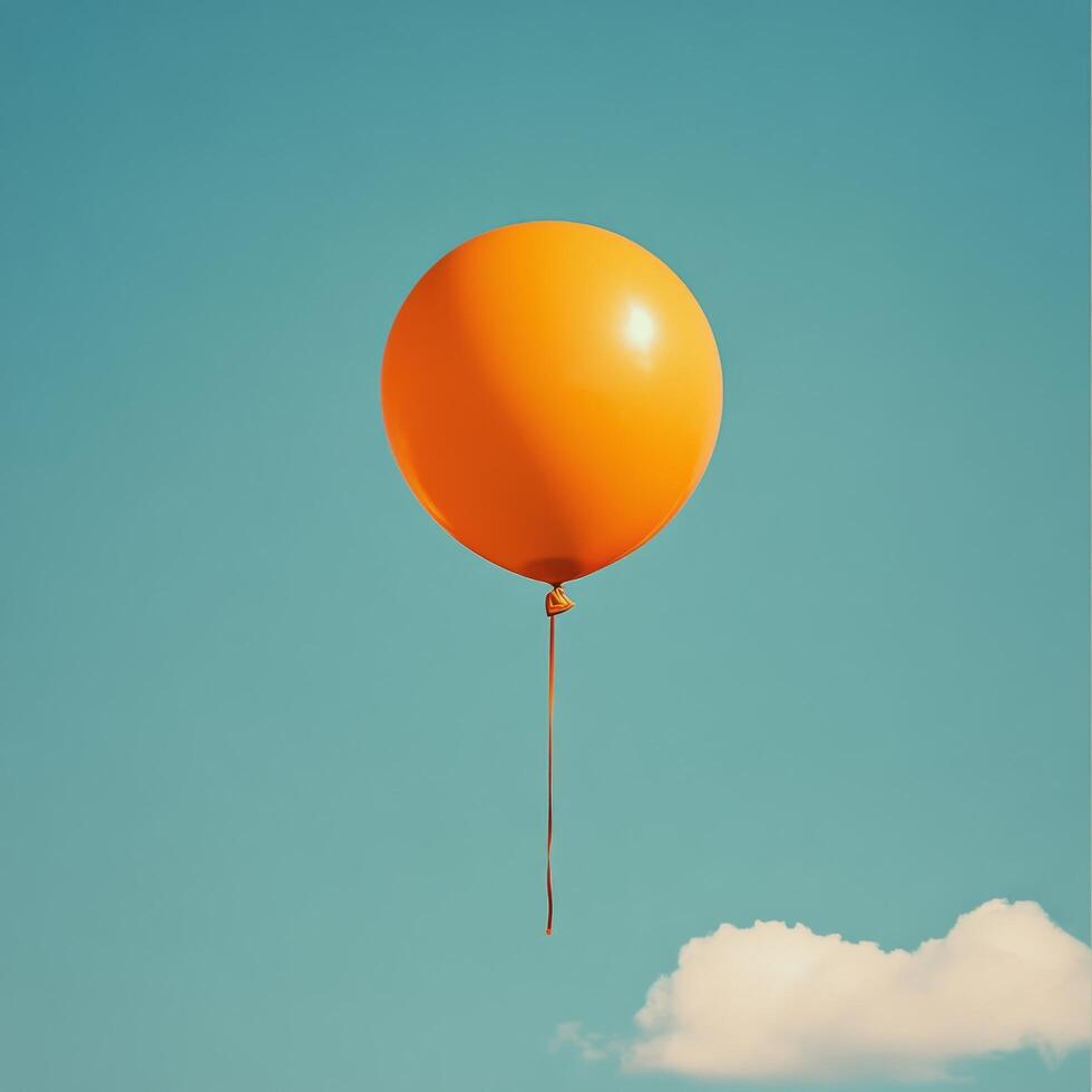 An orange balloon floating against a clear blue sky with fluffy white clouds in the afternoon photo