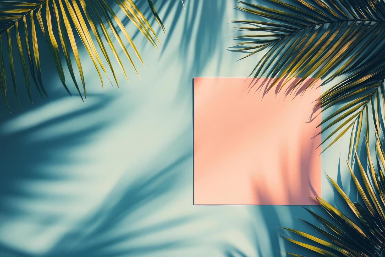 Stylish man in pink shirt poses against a blue wall with palm shadows in a bright setting photo