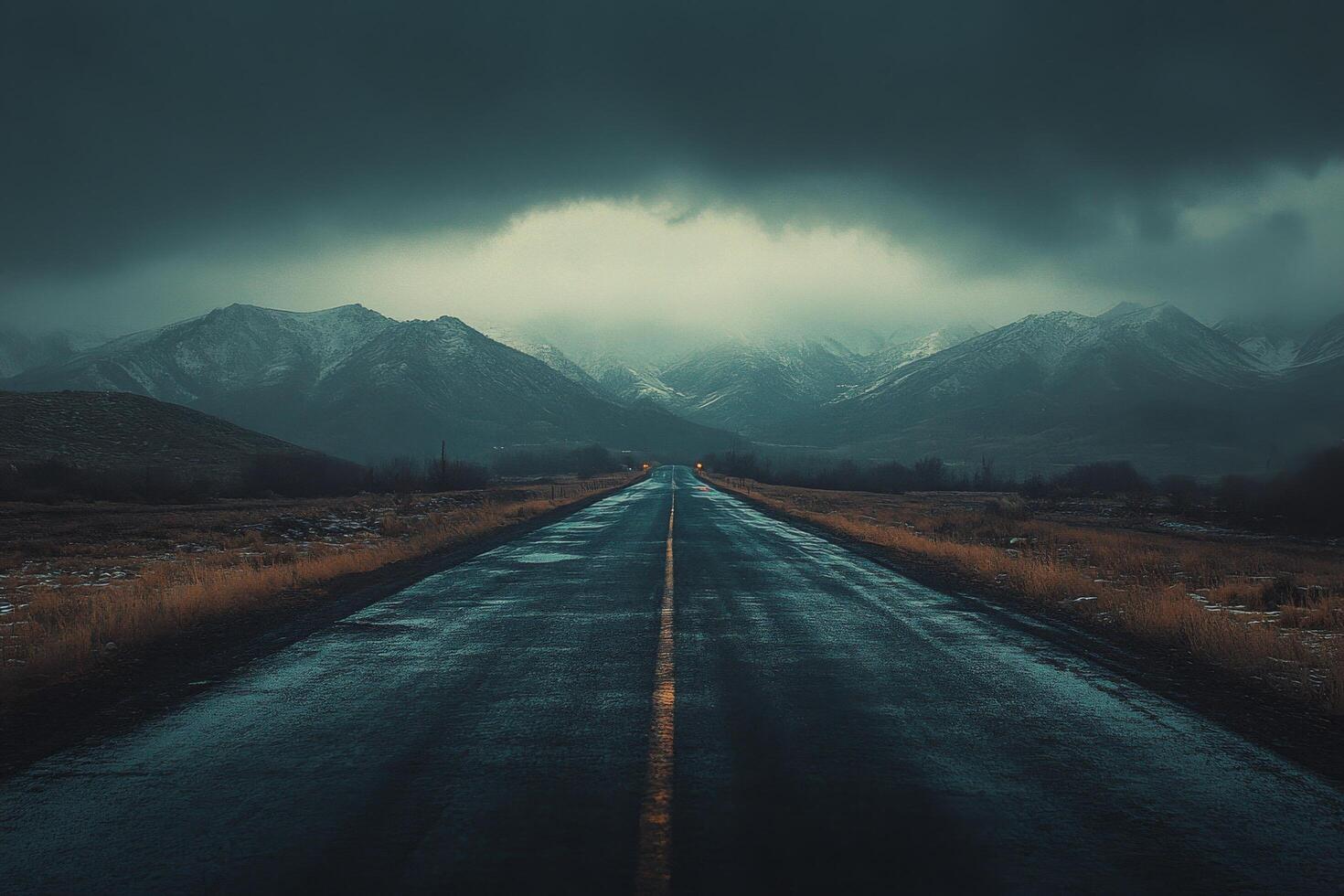 Dark and moody landscape with a winding road leading to distant mountains on a rainy day photo